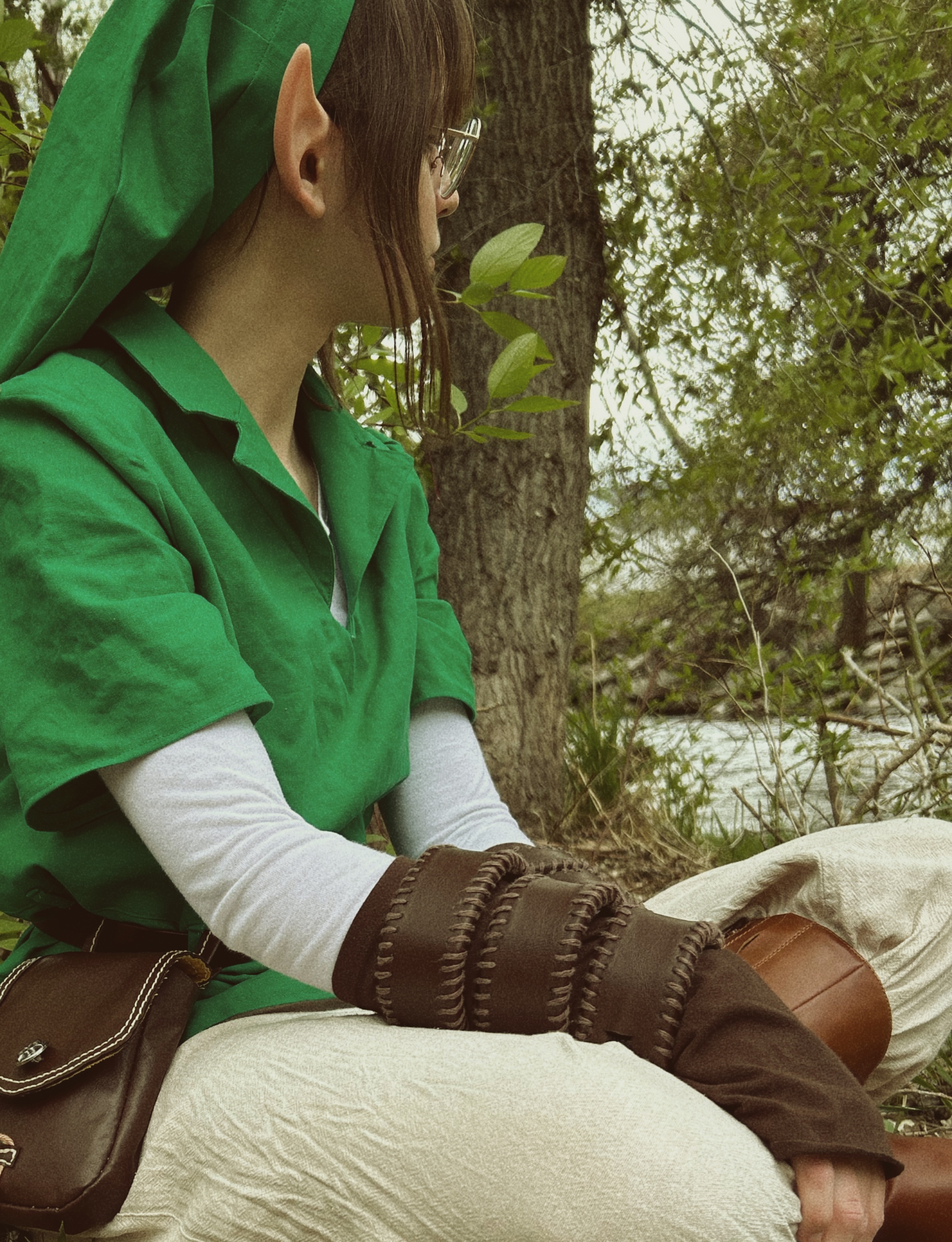 girl with brown hair and glasses in green tunic